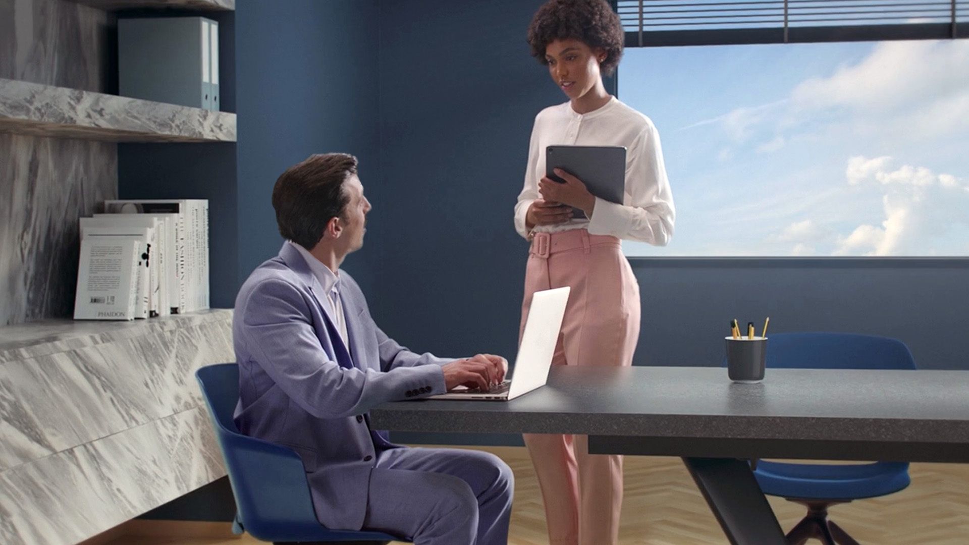 Two people sitting in a virtual 3d office
