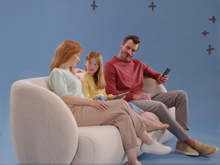 Image showing a family sitting on a sofa, behind the scenes view with a blue screen
